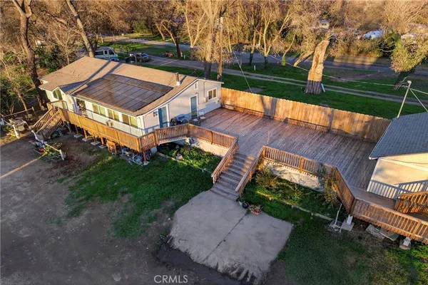 an aerial view of a house with garden space and street view