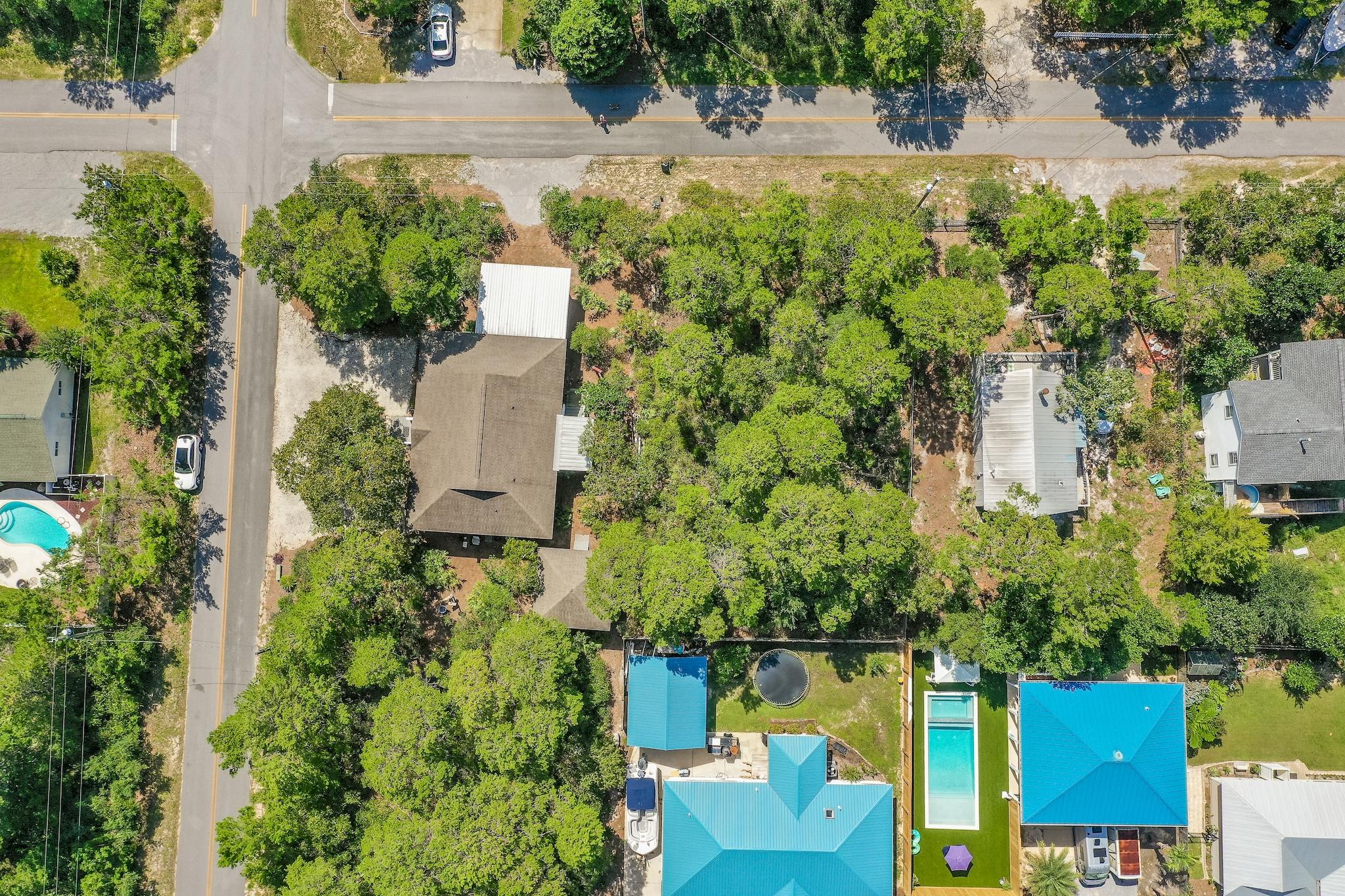 an aerial view of a house with a yard and lake view