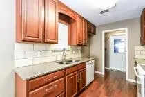 a kitchen with stainless steel appliances granite countertop a sink stove and cabinets