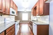 a kitchen with stainless steel appliances granite countertop a sink stove and cabinets