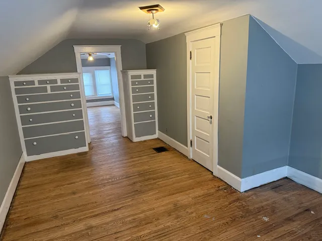 a dining room with furniture and wooden floor