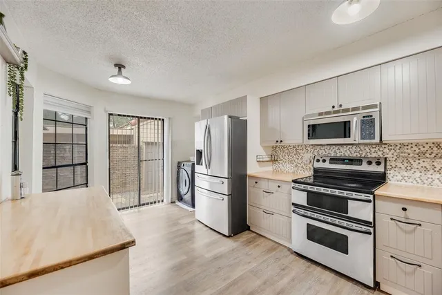 a kitchen with a refrigerator stove and microwave