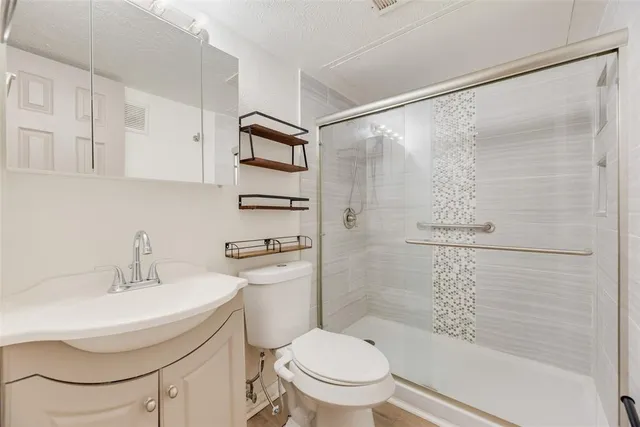 a bathroom with a sink toilet and shower