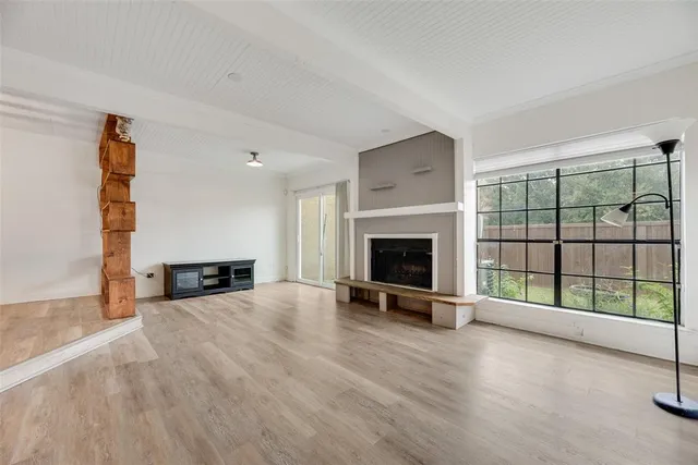 a view of a livingroom with a fireplace and a large window