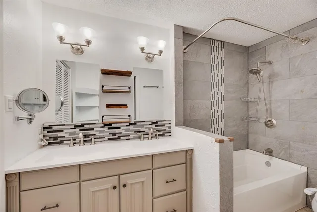 a bathroom with a sink a mirror and a bathtub
