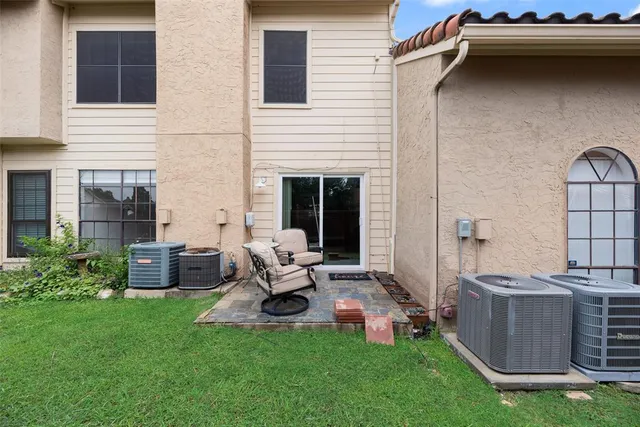 a backyard of a house with table and chairs