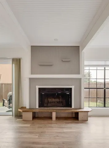 an empty room with fireplace and windows