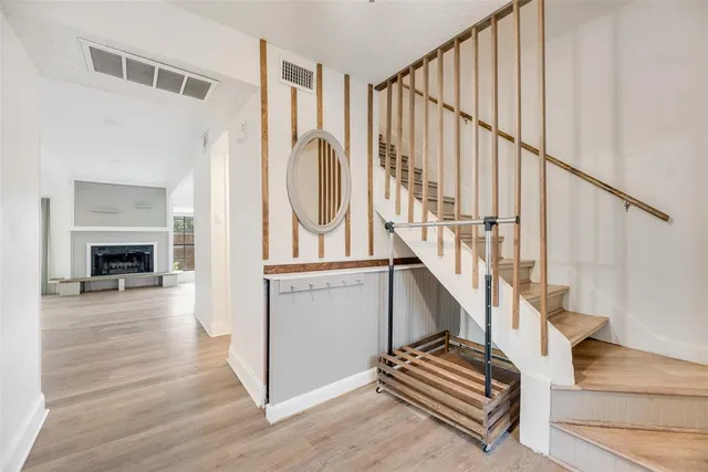 a view of entryway and hall with wooden floor