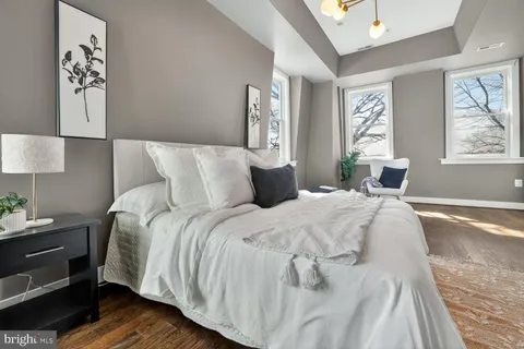 a bed sitting in a bedroom next to a window