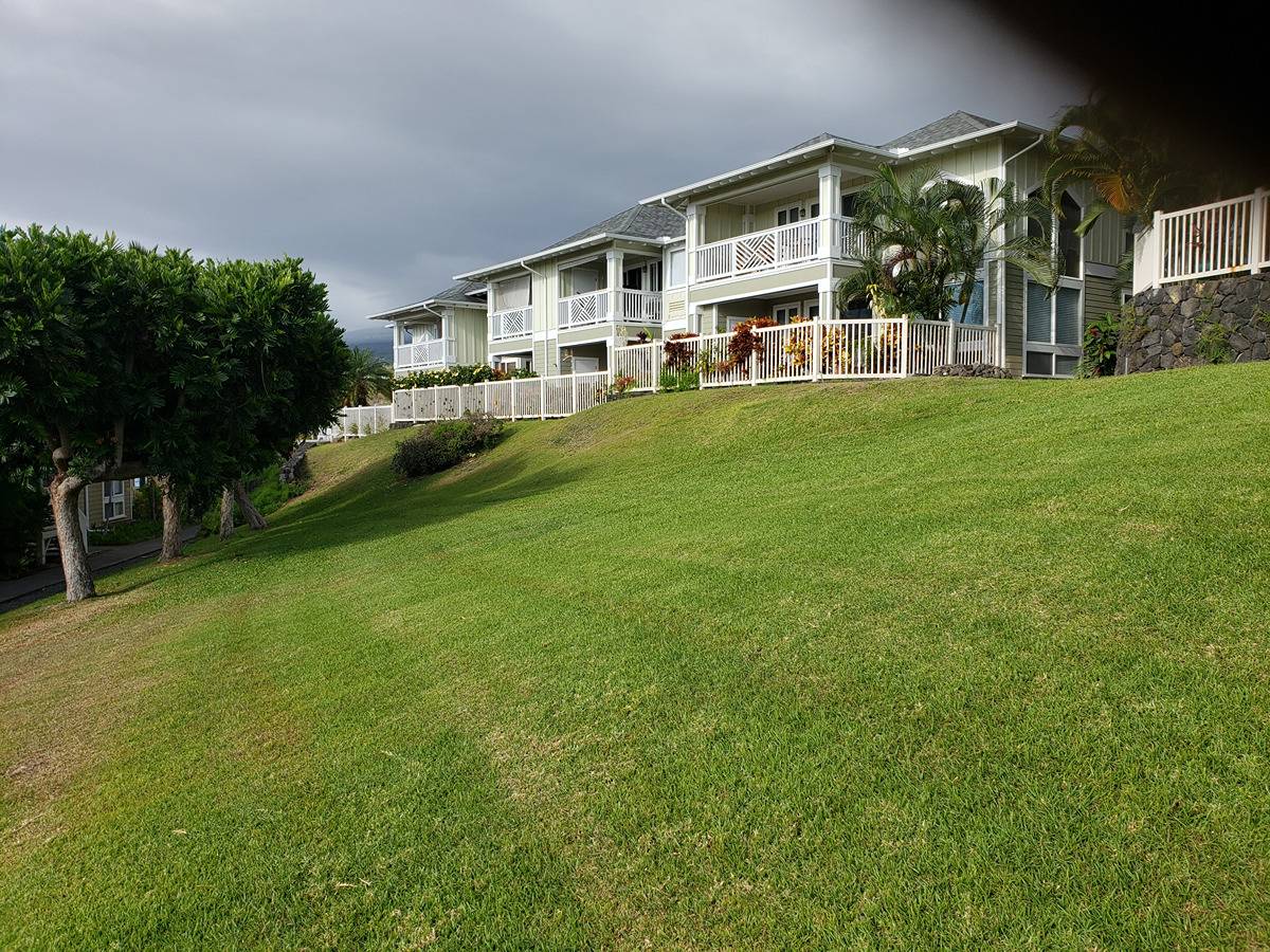 Kona Sea Ridge J2 - Privately situated, high above a small walkway alongside a sloping expanse of grass.