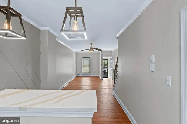 a view of entryway and hall with wooden floor