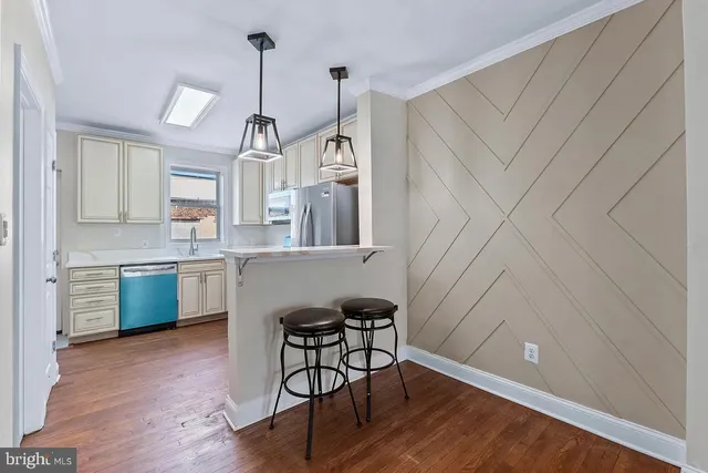a kitchen with sink cabinets and wooden floor
