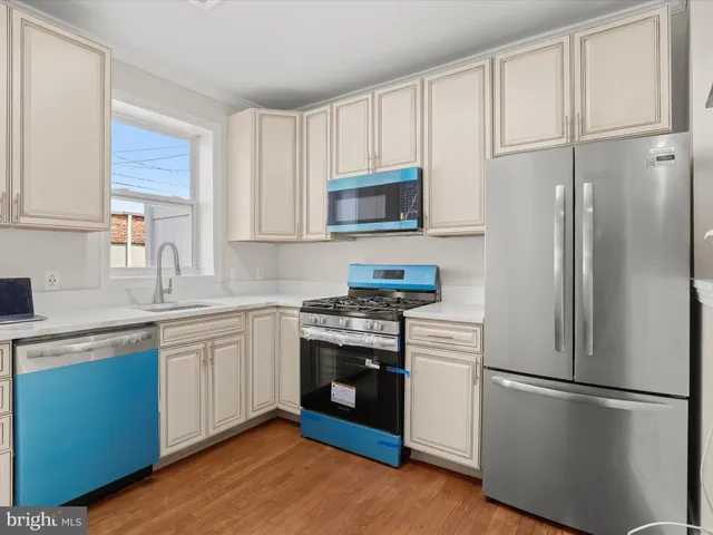 a kitchen with stainless steel appliances granite countertop a refrigerator stove a sink and a microwave