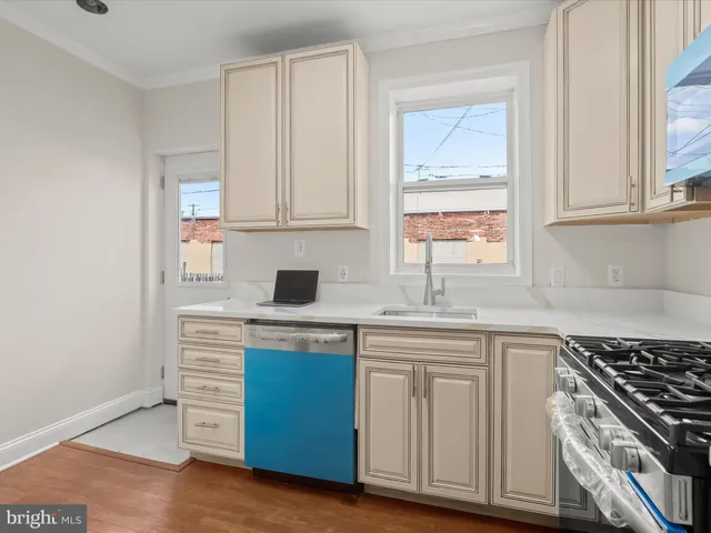 a kitchen with cabinets appliances and a window