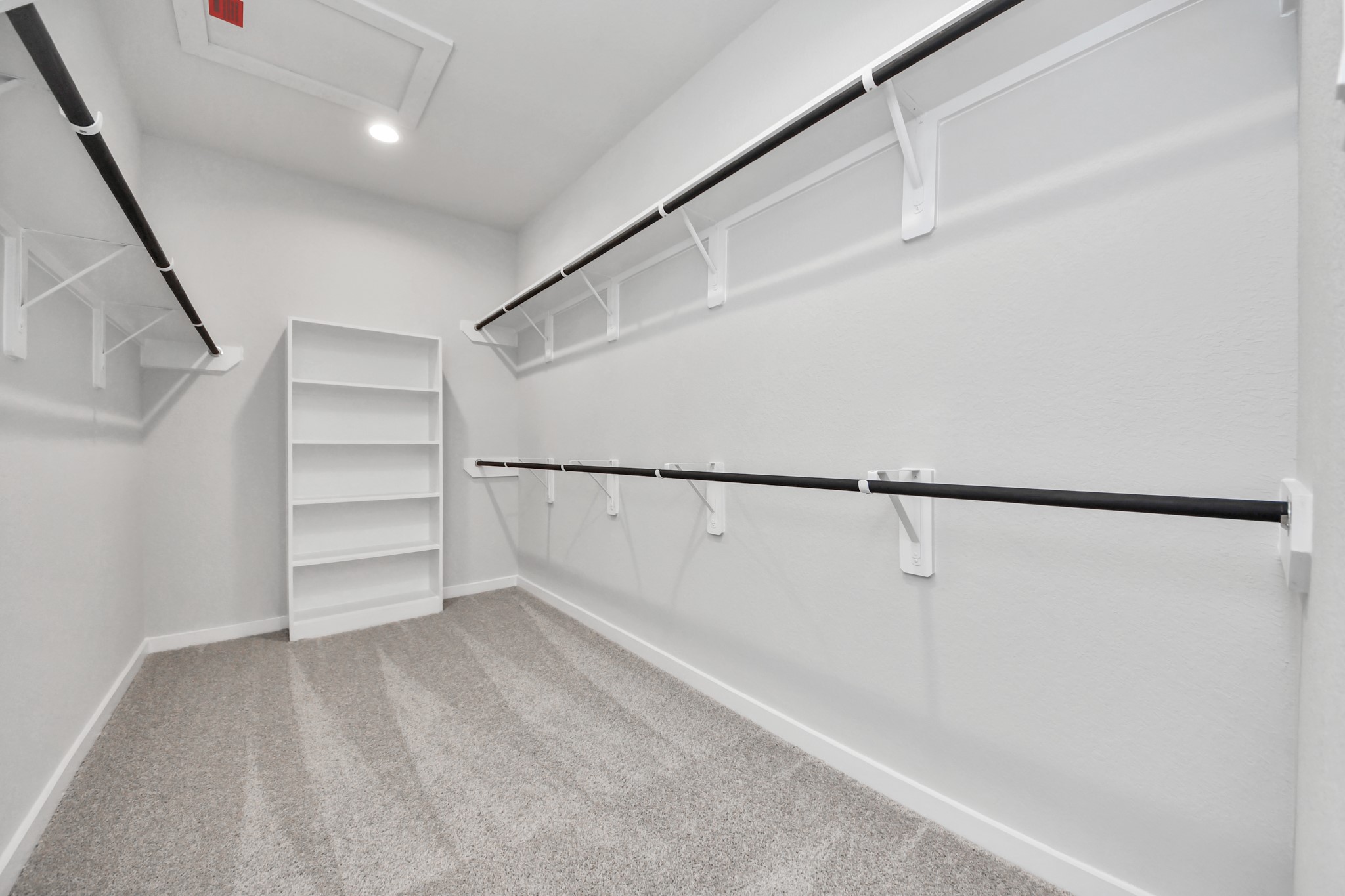 11114 Tulip Rdg Trail Houston, TX 77044 - Photo 22 of 30 Walk-in closet that epitomizes luxury and practicality. This generously sized space features built-in shelving, offering abundant room for impeccable organization. High ceilings and recessed lighting create a bright and welcoming ambiance. Sample photo of completed home with similar floor plan. Actual colors and selections may vary.