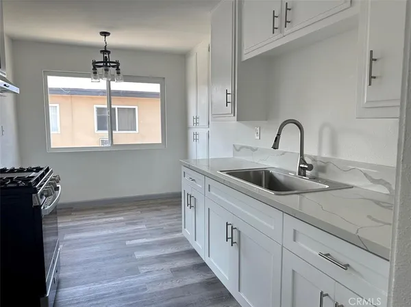 a kitchen with a sink and a stove top oven