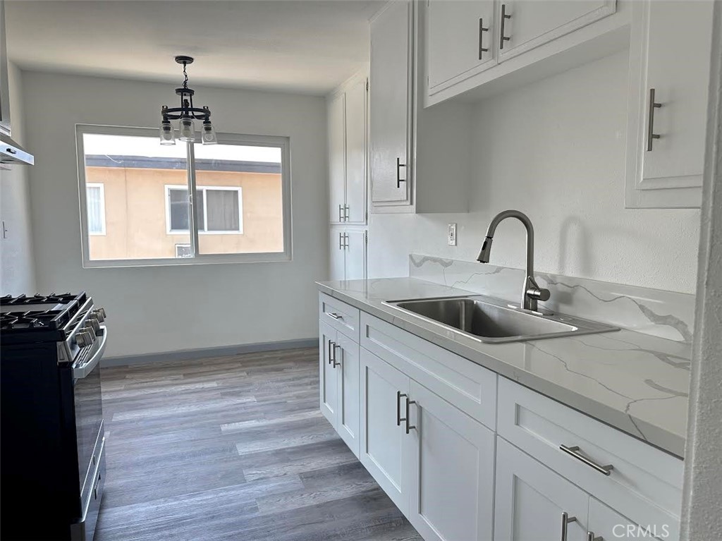 3060 Vineland Avenue, Unit 7 Baldwin Park, CA 91706 - Photo 3 of 14 a kitchen with a sink and a stove top oven