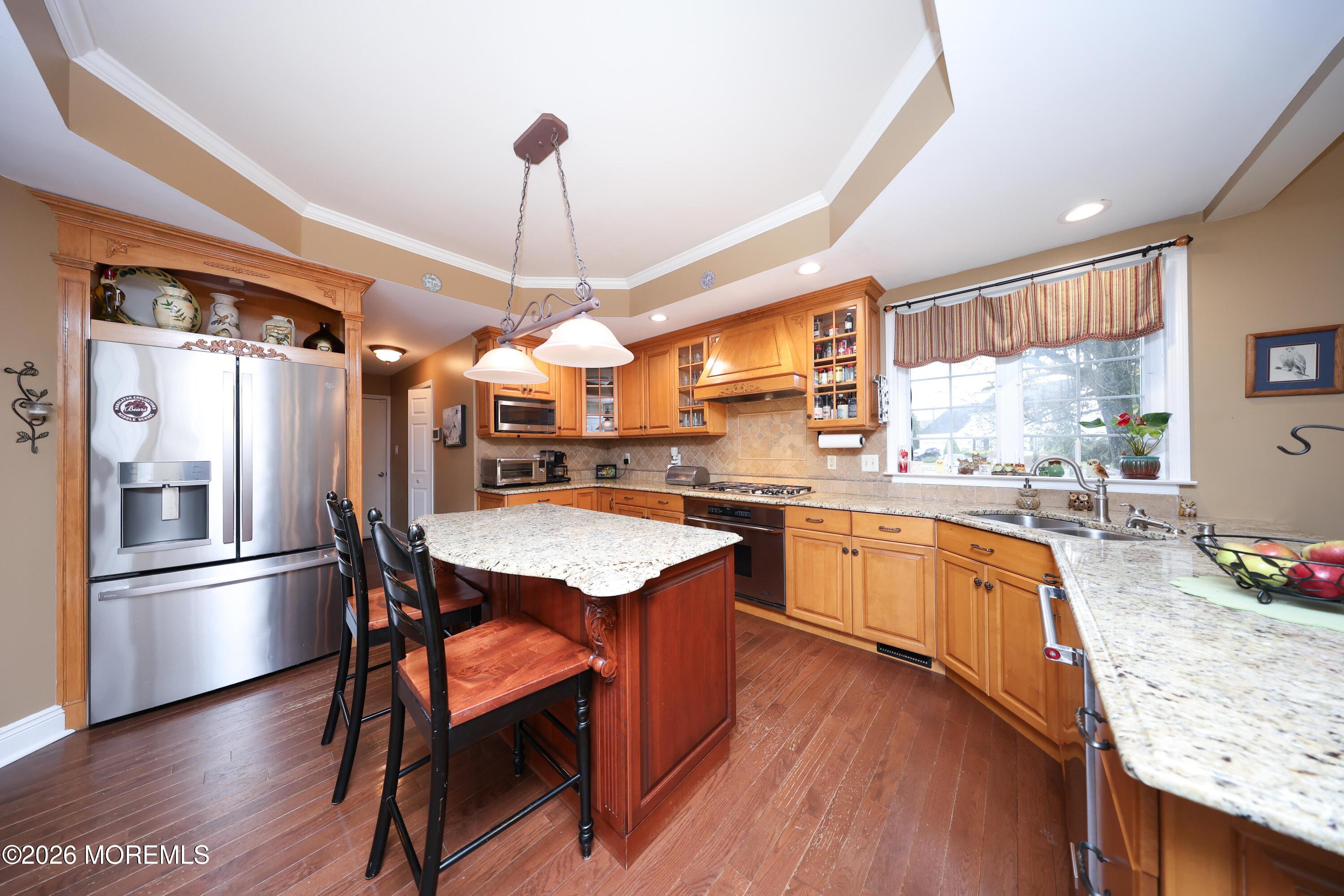 8 Clearbrook Court Howell, NJ 07731 - Photo 16 of 62 a kitchen with granite countertop wooden floors and stainless steel appliances
