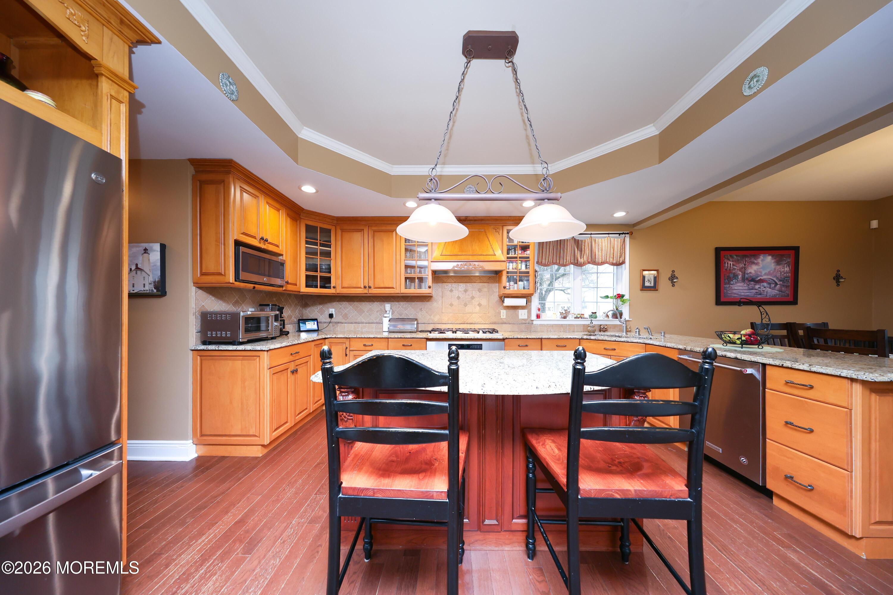 8 Clearbrook Court Howell, NJ 07731 - Photo 18 of 62 a dining room with stainless steel appliances granite countertop a table chairs and a refrigerator