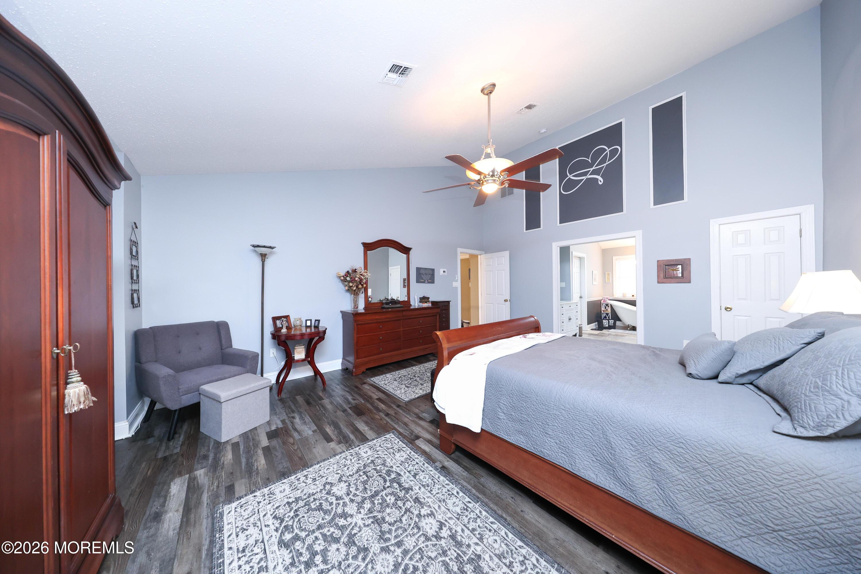 8 Clearbrook Court Howell, NJ 07731 - Photo 27 of 62 a bedroom with a bed chandelier and a chair