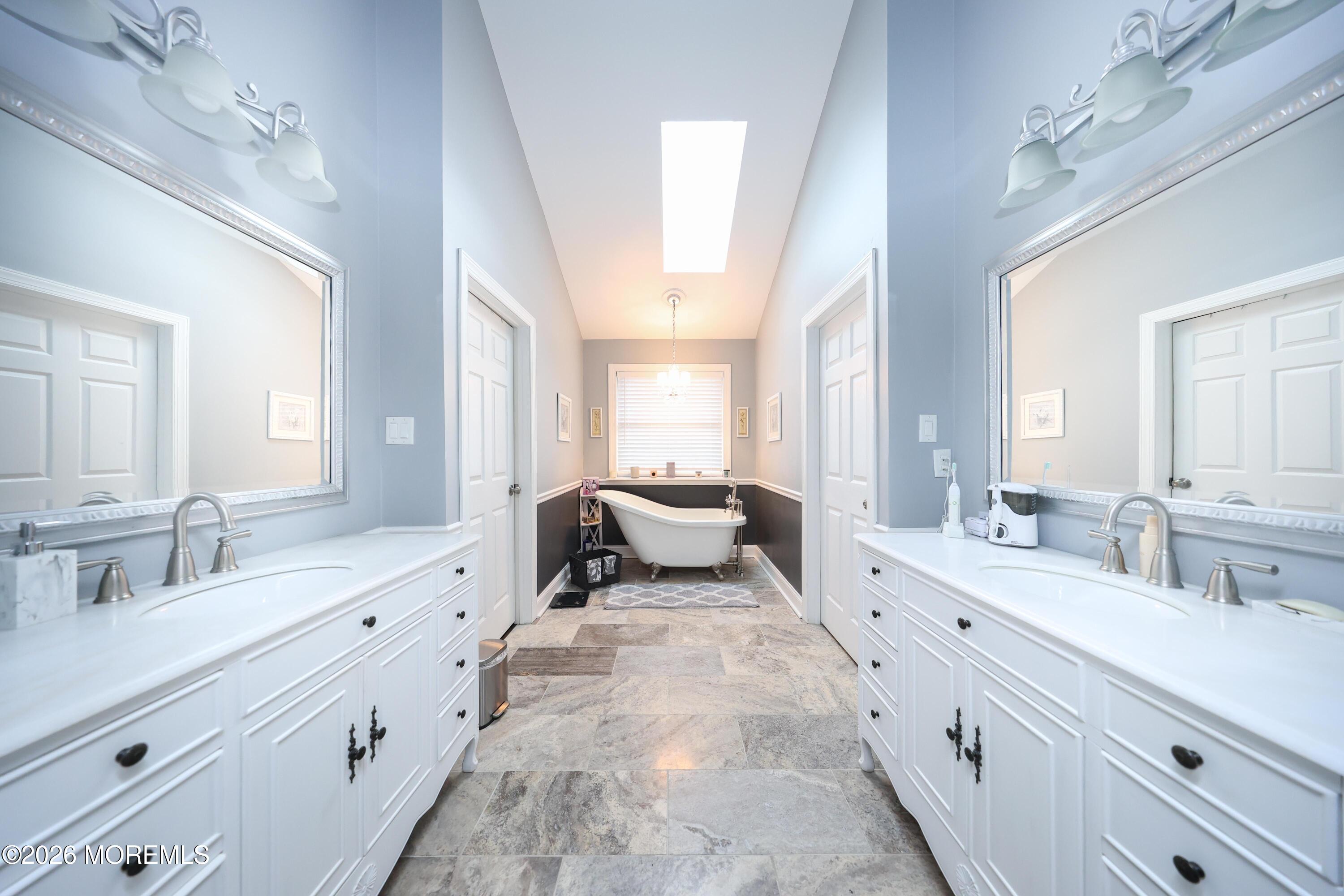 8 Clearbrook Court Howell, NJ 07731 - Photo 28 of 62 a spacious en suite bathroom with a double vanity sink and mirror