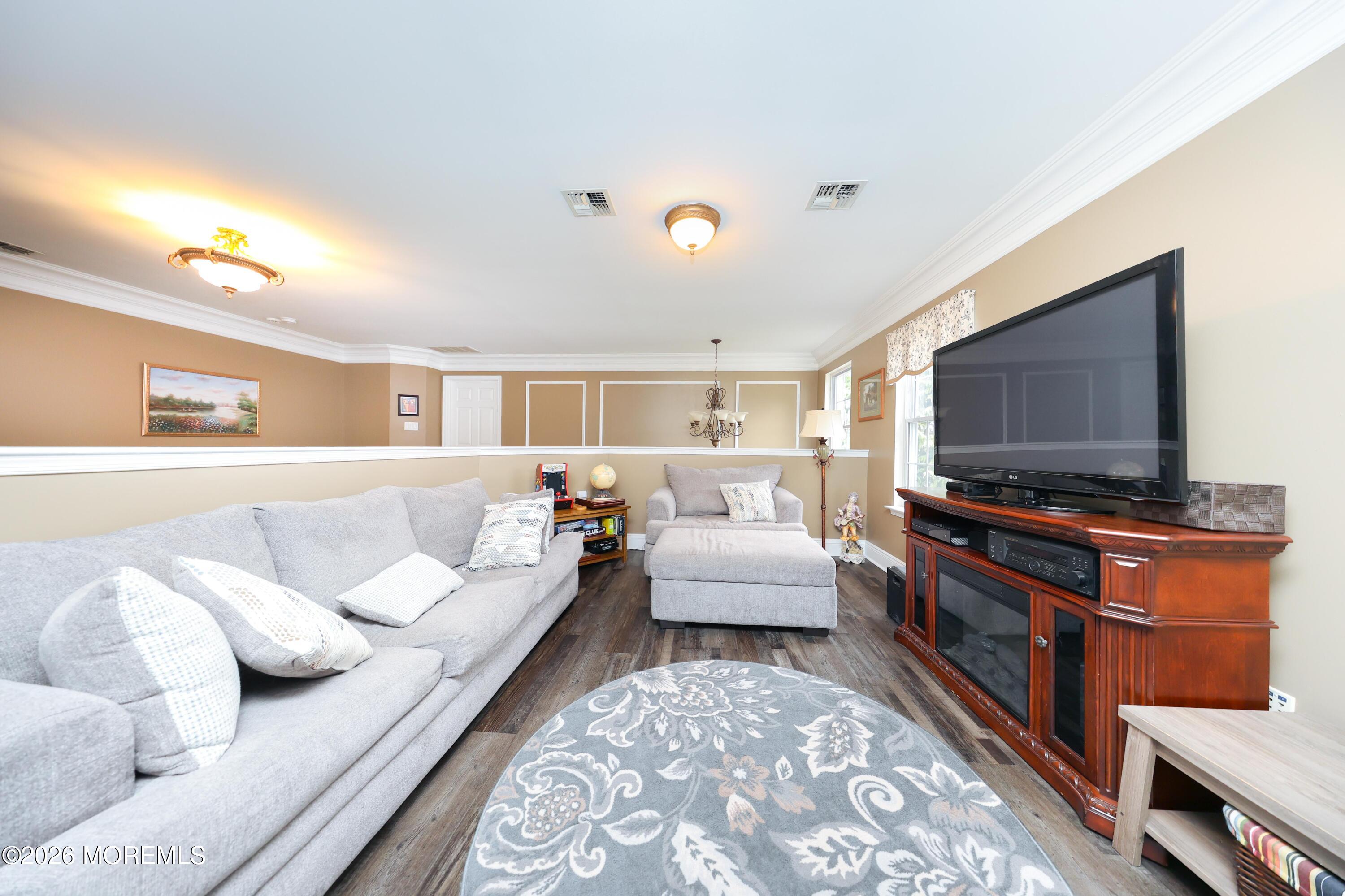 8 Clearbrook Court Howell, NJ 07731 - Photo 38 of 62 a living room with furniture and a flat screen tv