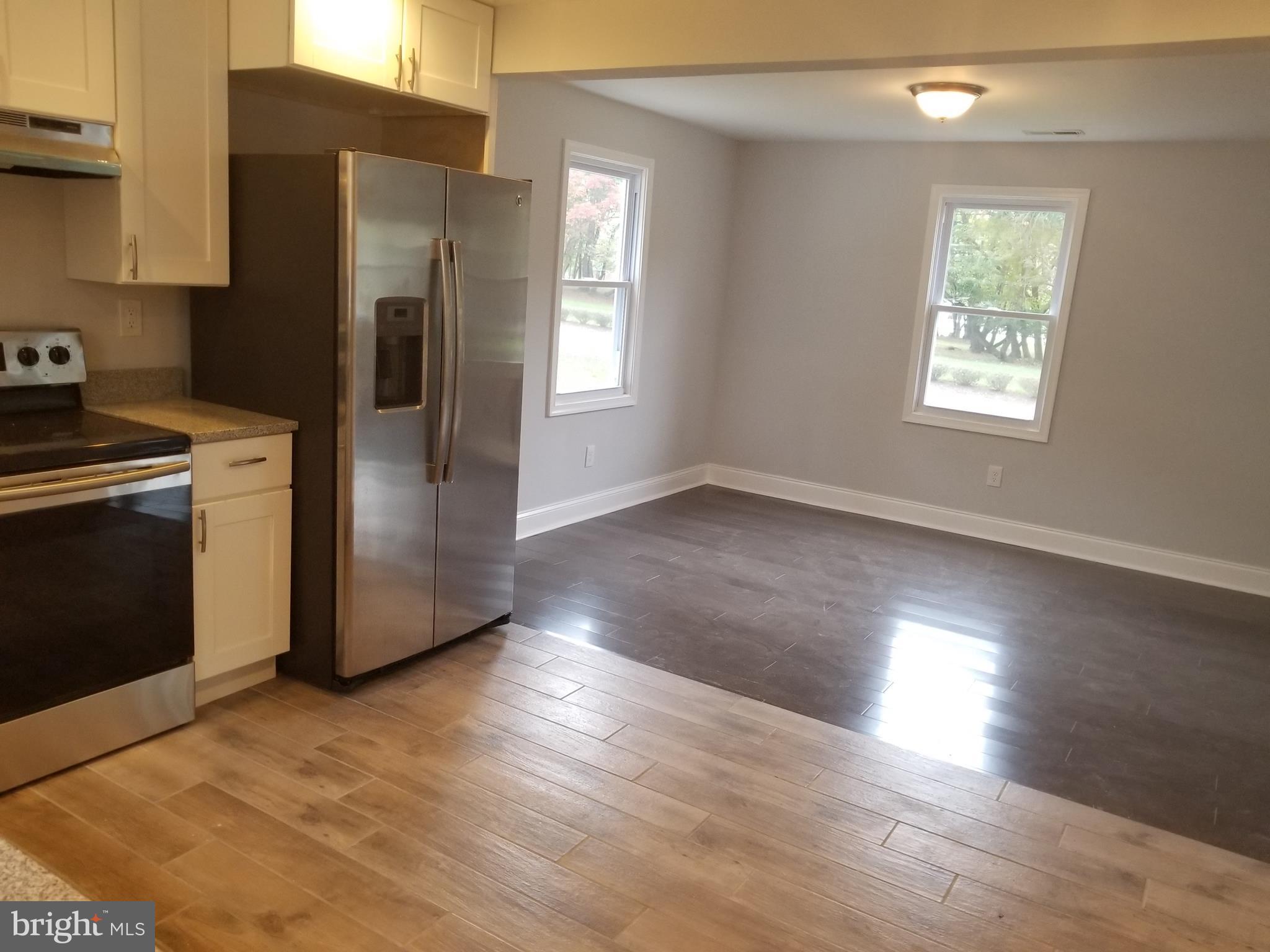 6828 Campfield Road Baltimore, MD 21207 - Photo 4 of 26 a kitchen with stainless steel appliances a refrigerator stove and sink