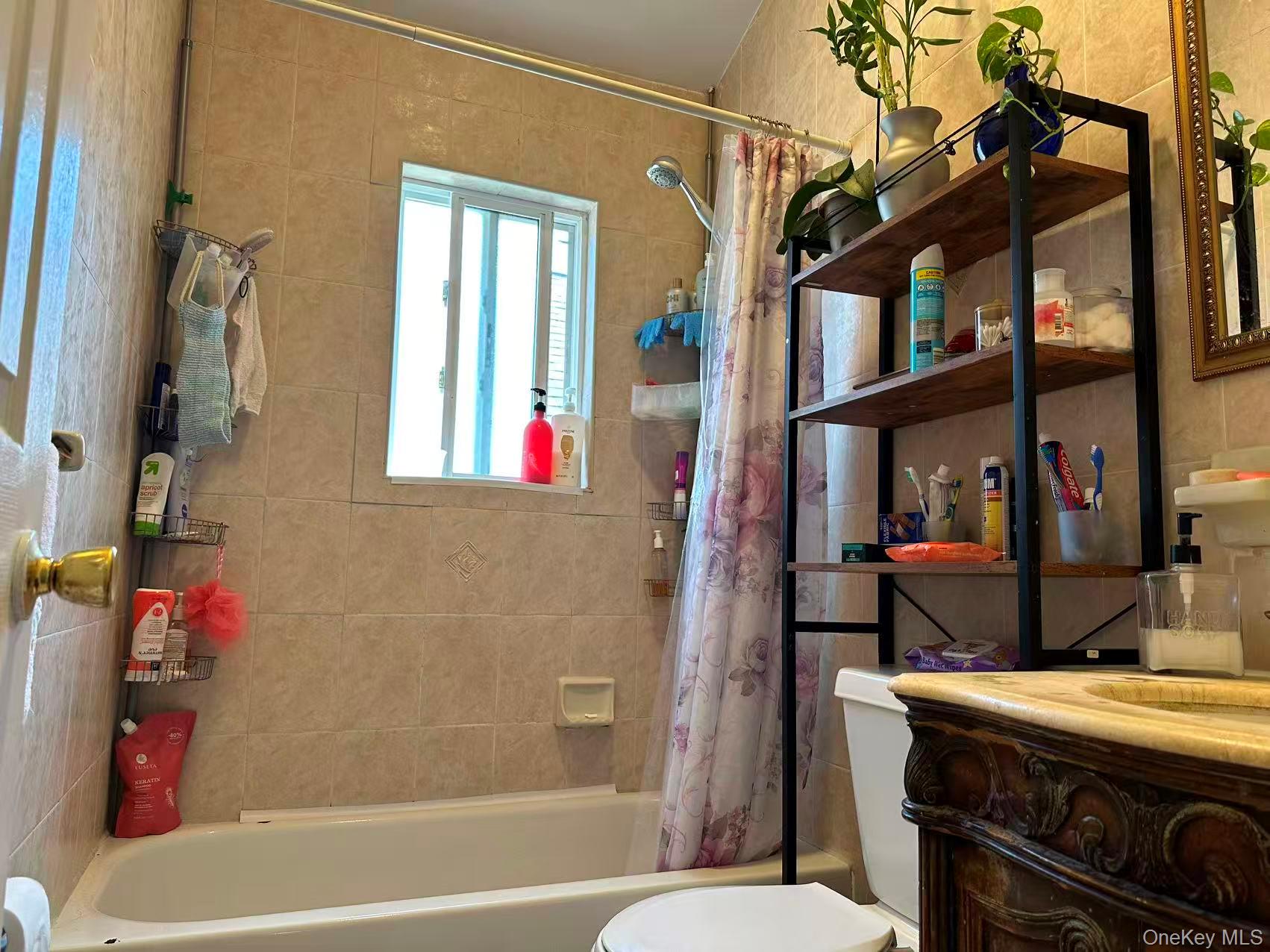 80-29 57th Street Queens, NY 11385 - Photo 4 of 12 Full bathroom featuring shower / tub combo with curtain and vanity