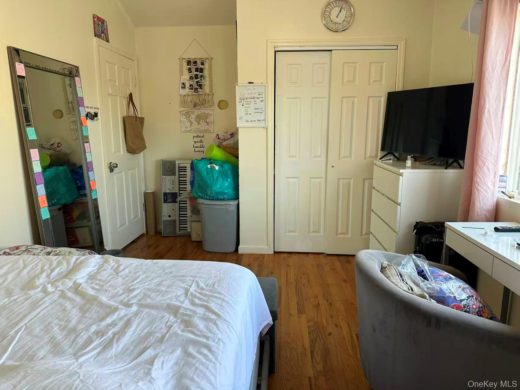 80-29 57th Street Queens, NY 11385 - Photo 8 of 12 Bedroom featuring wood finished floors and a closet