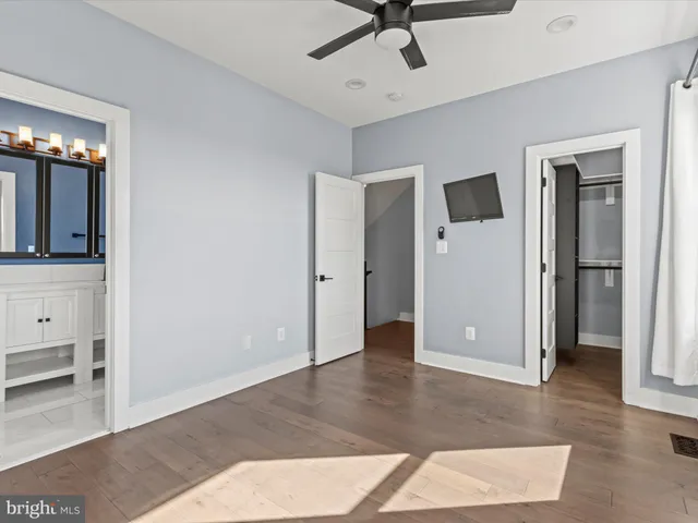 a view of a hallway with entryway wooden floor and front door
