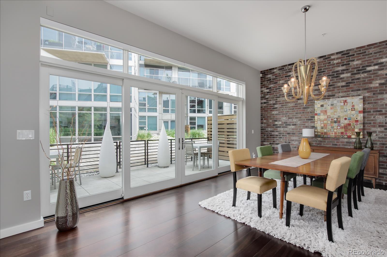 1640 Little Raven Street Denver, CO 80202 - Photo 14 of 37 a view of a dining room with furniture window and wooden floor