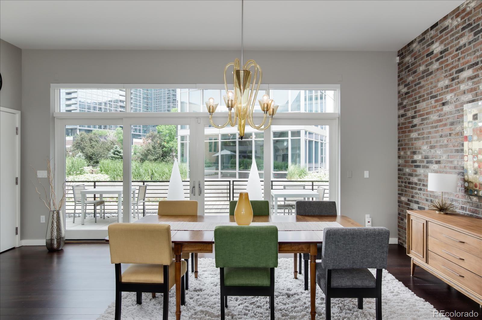 1640 Little Raven Street Denver, CO 80202 - Photo 15 of 37 a dining room with furniture a chandelier and wooden floor