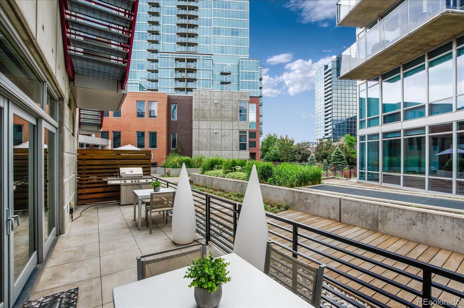 1640 Little Raven Street Denver, CO 80202 - Photo 17 of 37 a view of a patio with table and chairs and potted plants