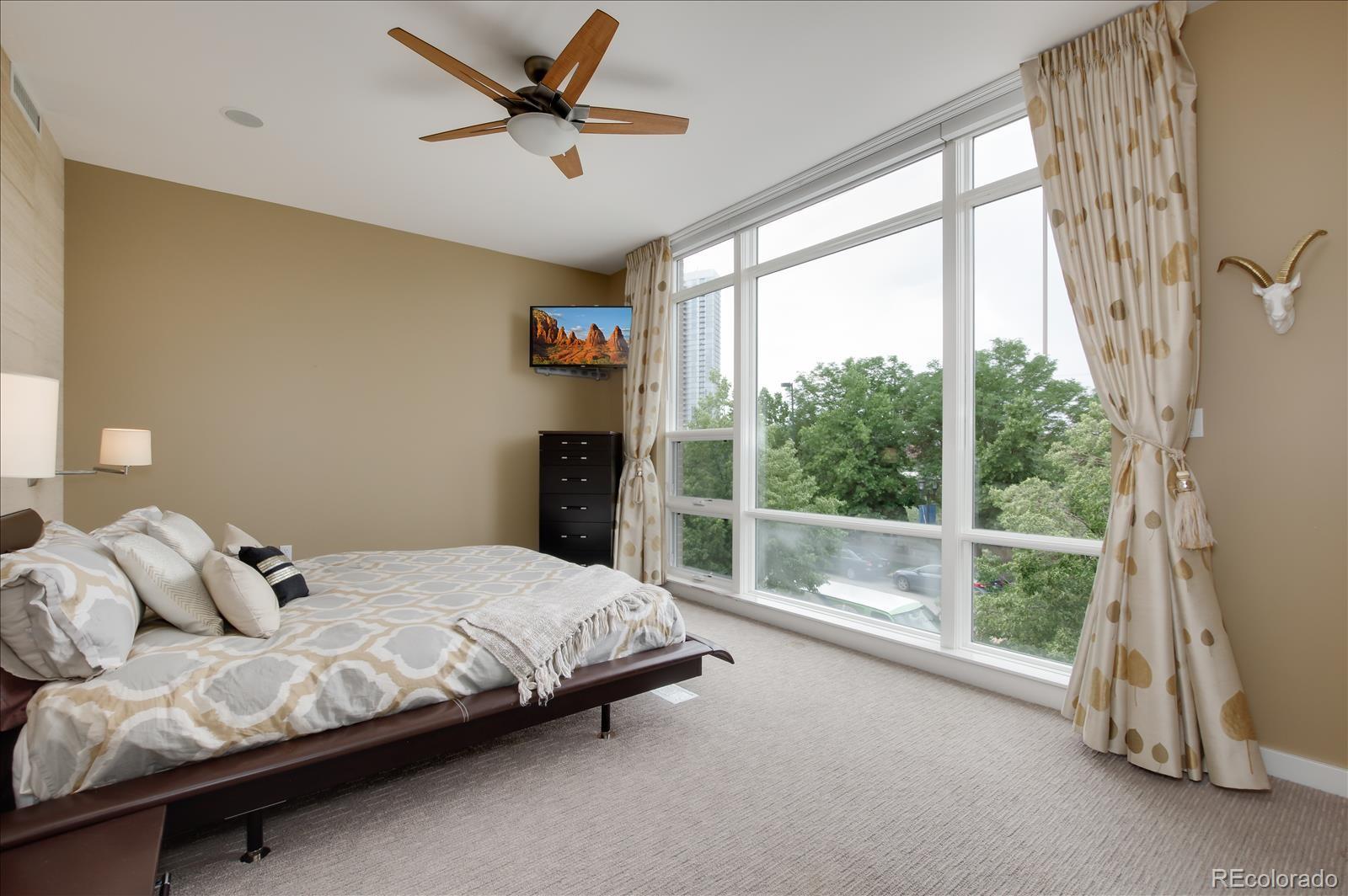 1640 Little Raven Street Denver, CO 80202 - Photo 20 of 37 a bedroom with a bed and a large window