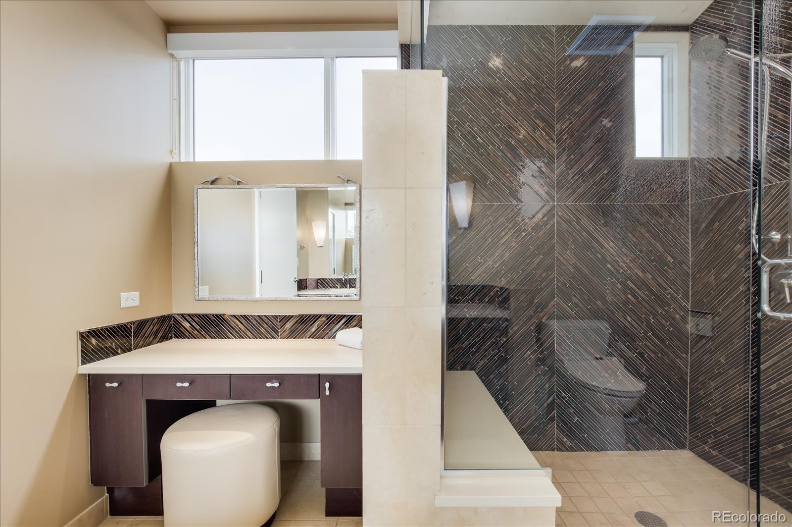 1640 Little Raven Street Denver, CO 80202 - Photo 23 of 37 a bathroom with a sink mirror and shower