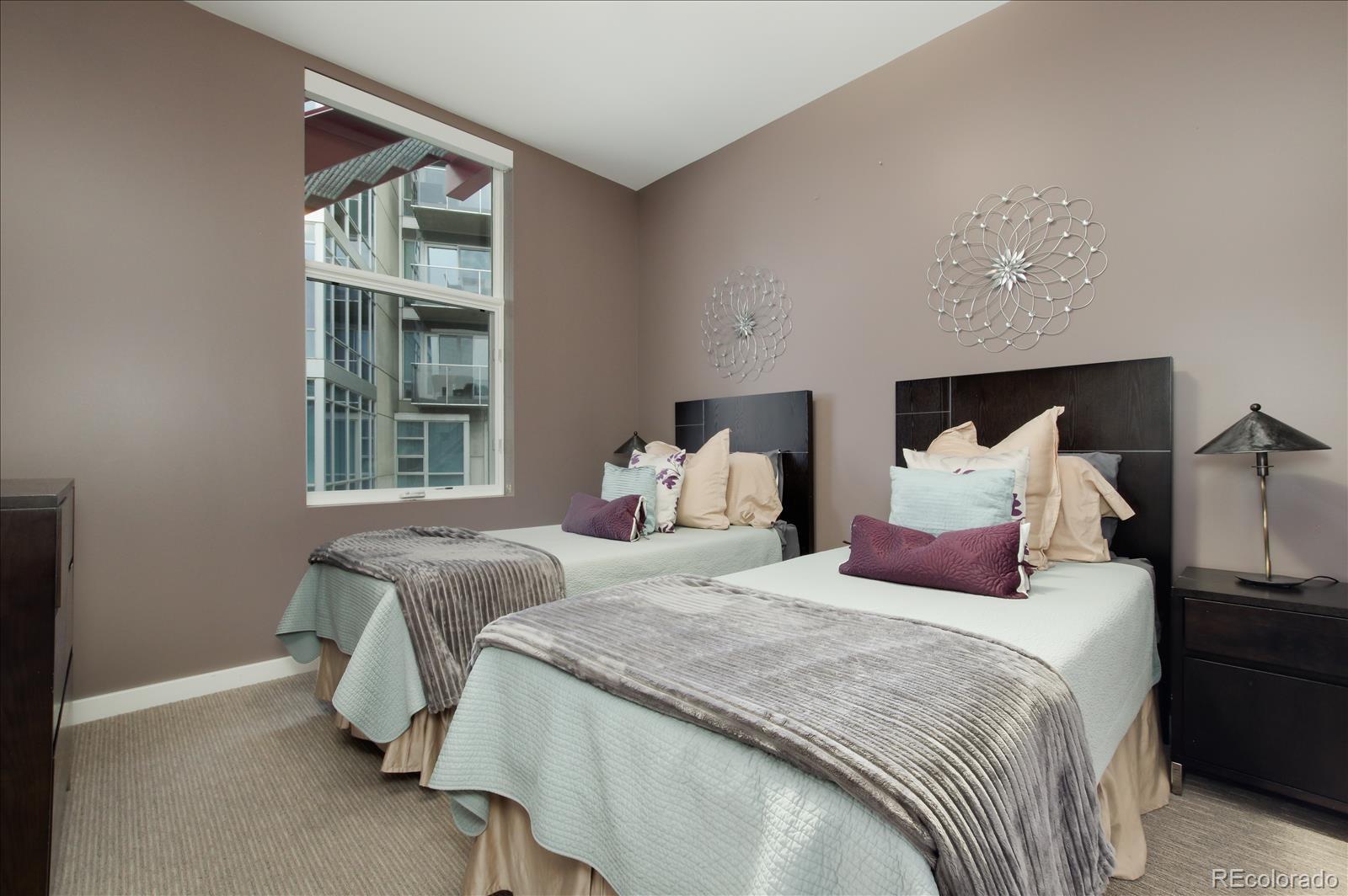 1640 Little Raven Street Denver, CO 80202 - Photo 24 of 37 a bedroom with a bed and wooden floor