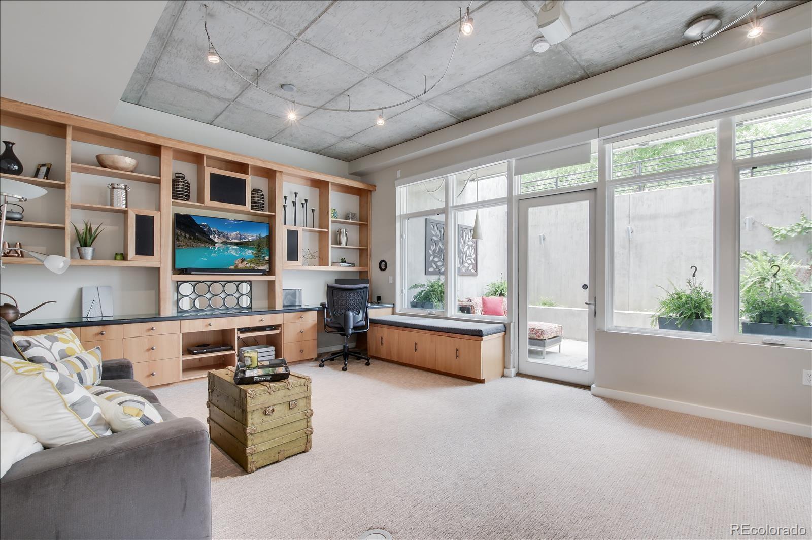 1640 Little Raven Street Denver, CO 80202 - Photo 26 of 37 a living room with furniture and a large window