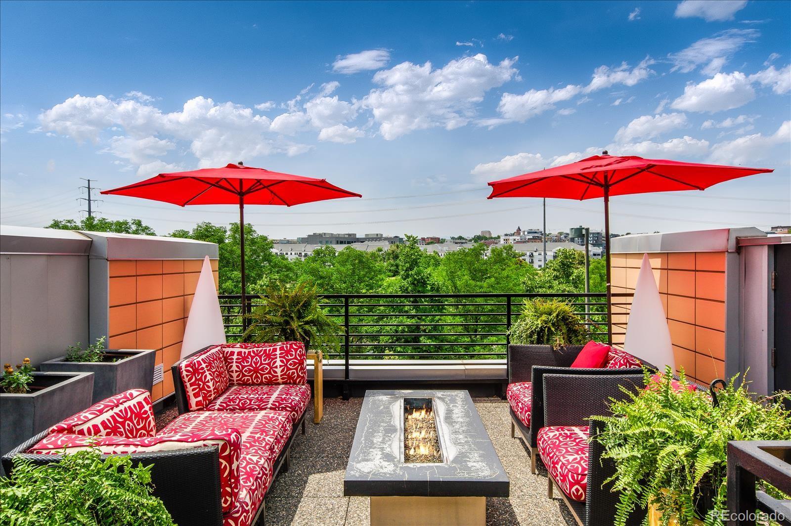 1640 Little Raven Street Denver, CO 80202 - Photo 30 of 37 an outdoor sitting area with furniture and umbrella