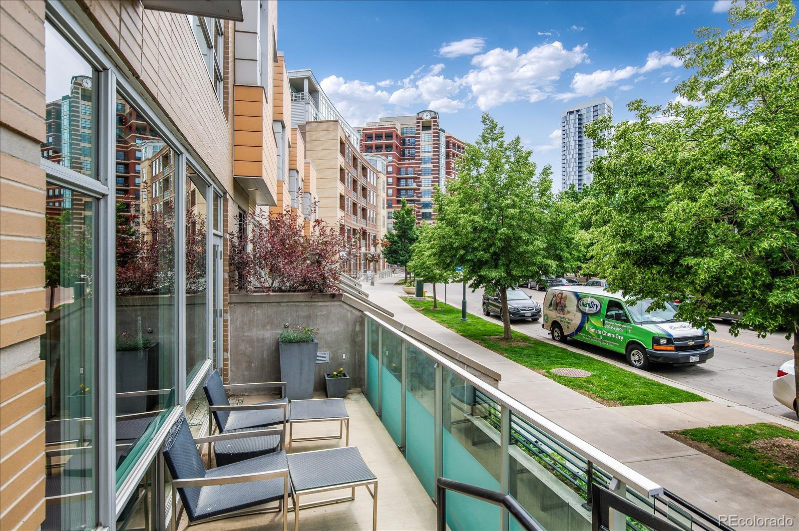 1640 Little Raven Street Denver, CO 80202 - Photo 3 of 37 a balcony with tall trees in front of it