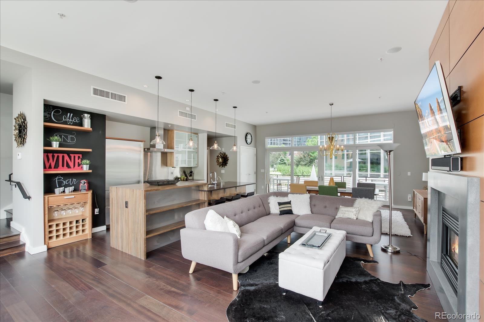 1640 Little Raven Street Denver, CO 80202 - Photo 5 of 37 a living room with furniture a large window and a flat screen tv