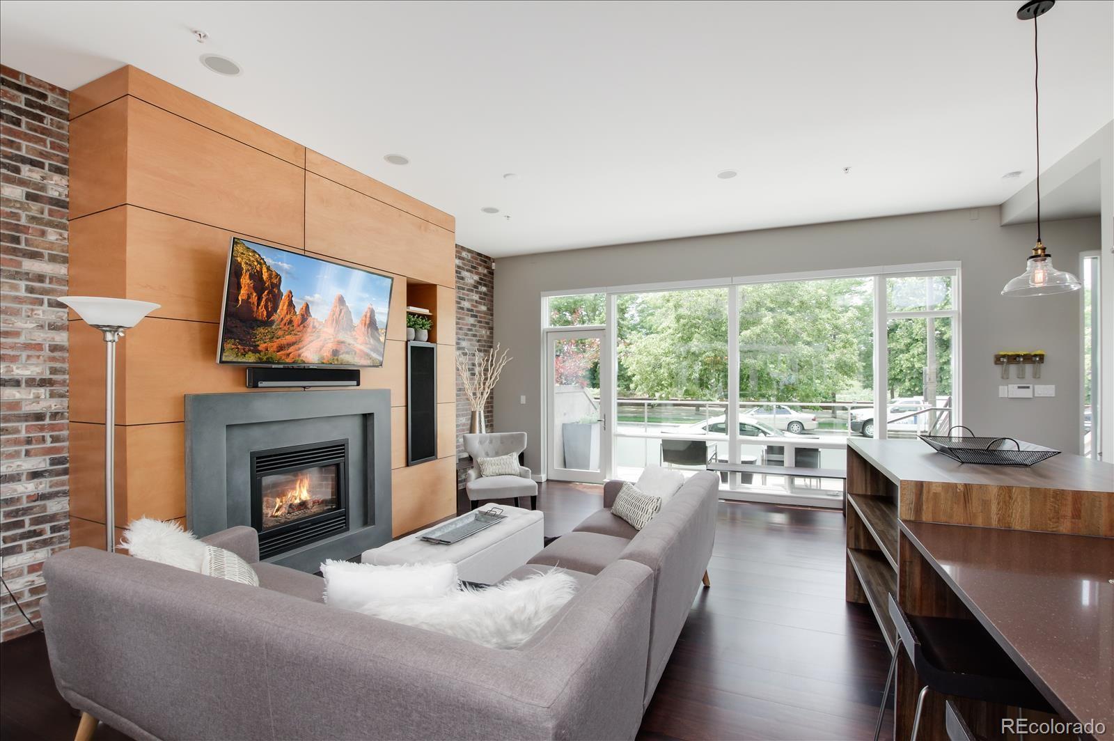 1640 Little Raven Street Denver, CO 80202 - Photo 7 of 37 a living room with furniture fireplace and large windows