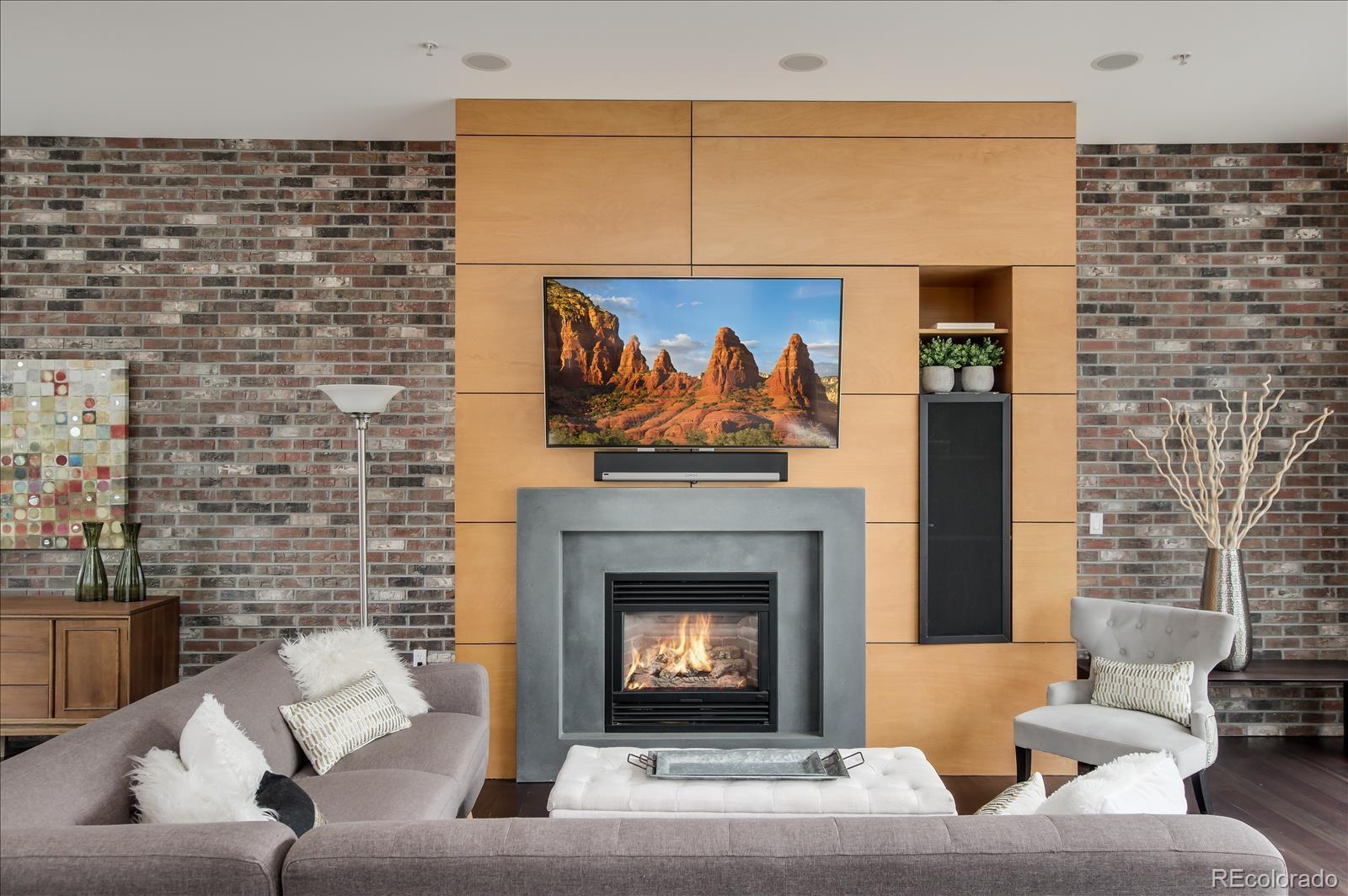 1640 Little Raven Street Denver, CO 80202 - Photo 8 of 37 a living room with furniture a fireplace and a flat screen tv