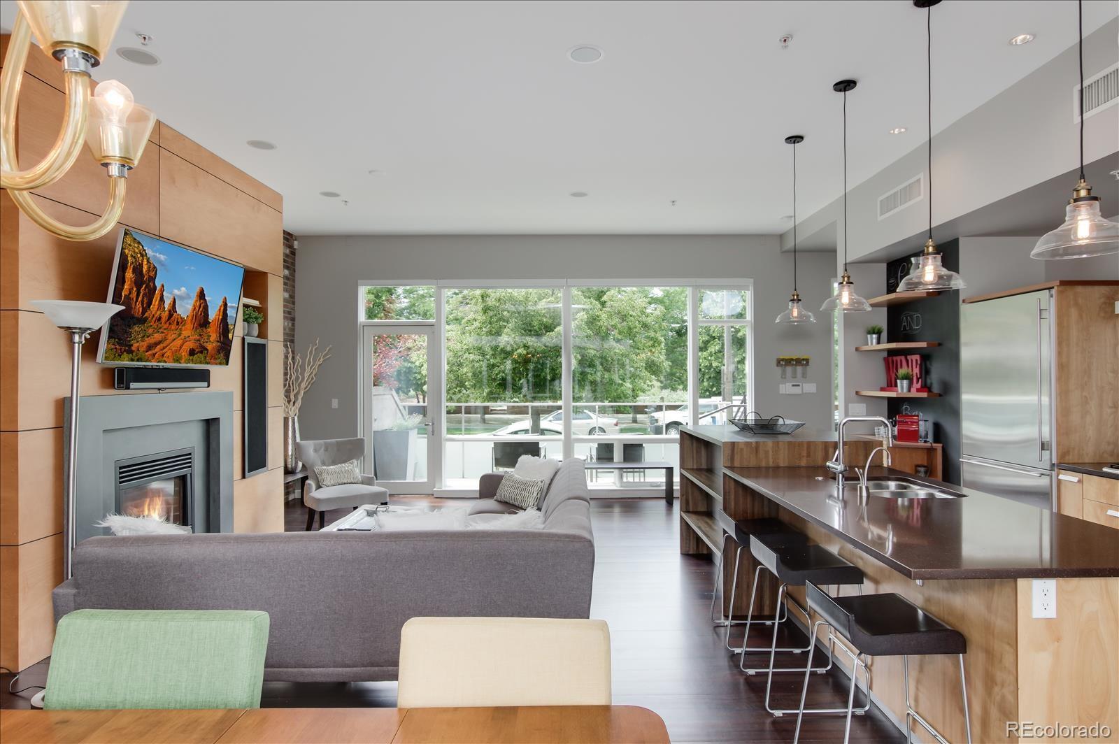 1640 Little Raven Street Denver, CO 80202 - Photo 9 of 37 a living room with fireplace furniture and a large window