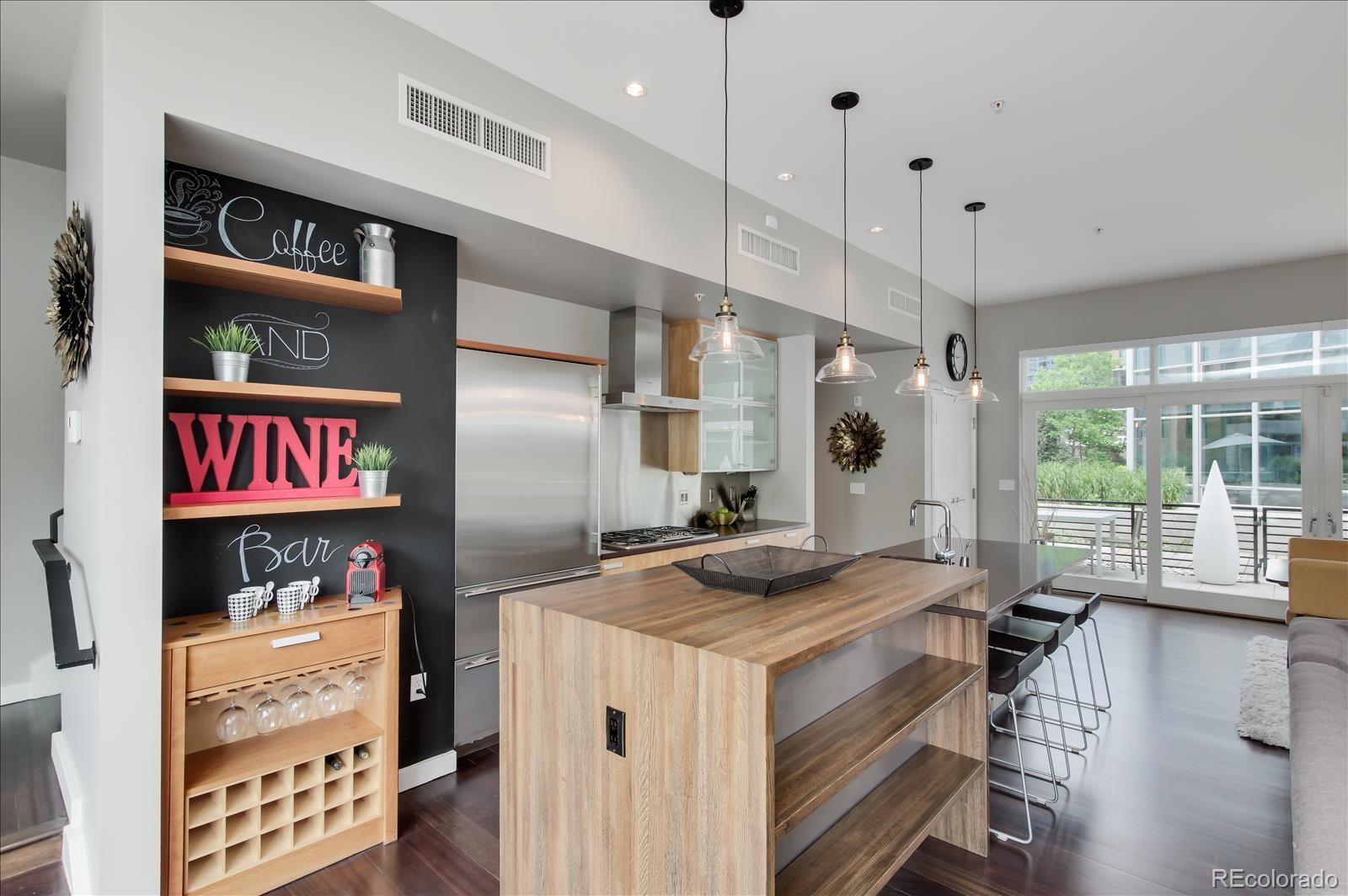 1640 Little Raven Street Denver, CO 80202 - Photo 10 of 37 a kitchen with stainless steel appliances granite countertop a sink a stove and a refrigerator