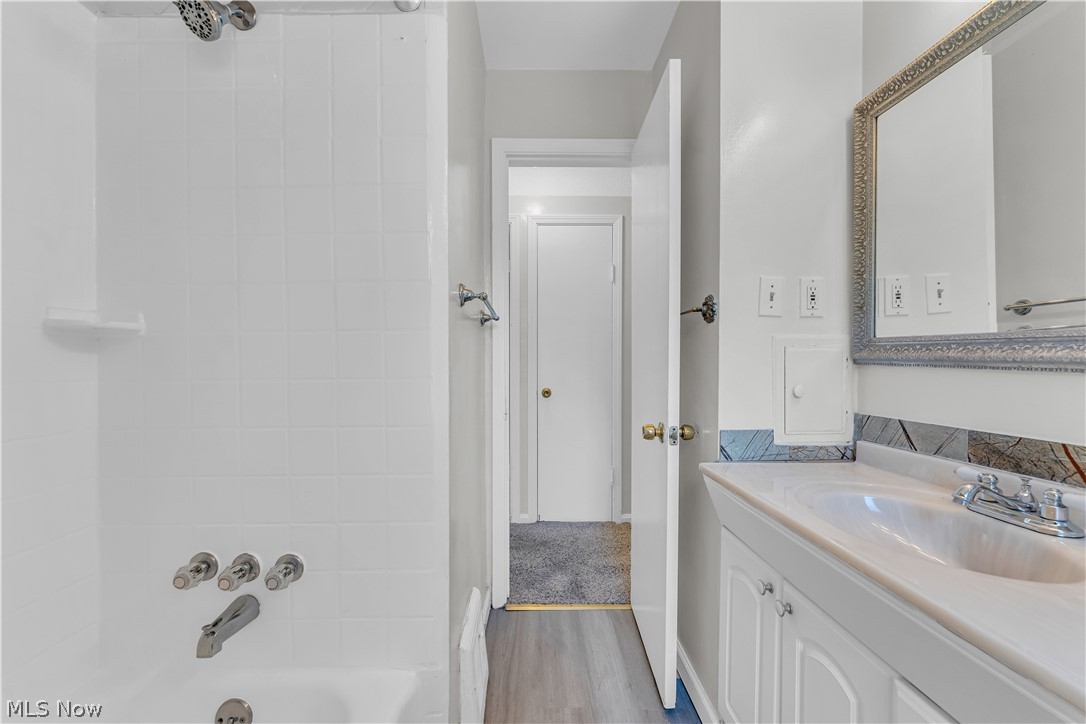 3842 Wallingford Road South Euclid, OH 44121 - Photo 20 of 31 Bathroom with shower / bath combination, large vanity, and wood-type flooring