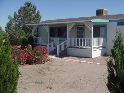 11176 Smoke Tree Road Victorville, CA 92395 - Photo 1 of 1 a front view of a house having yard