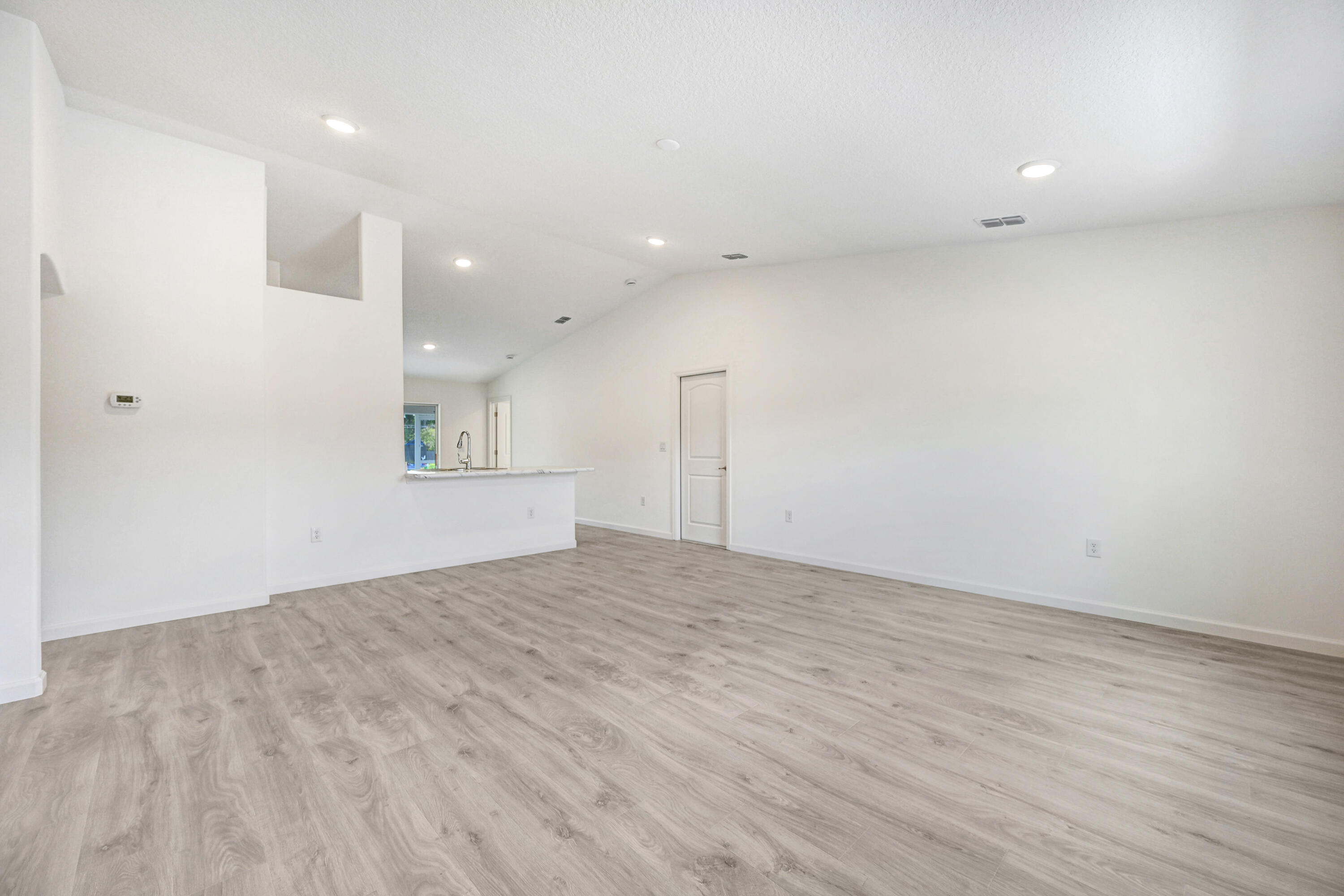 239 Trilby Road Southwest Palm Bay, FL 32908 - Photo 7 of 38 a view of empty room with wooden floor