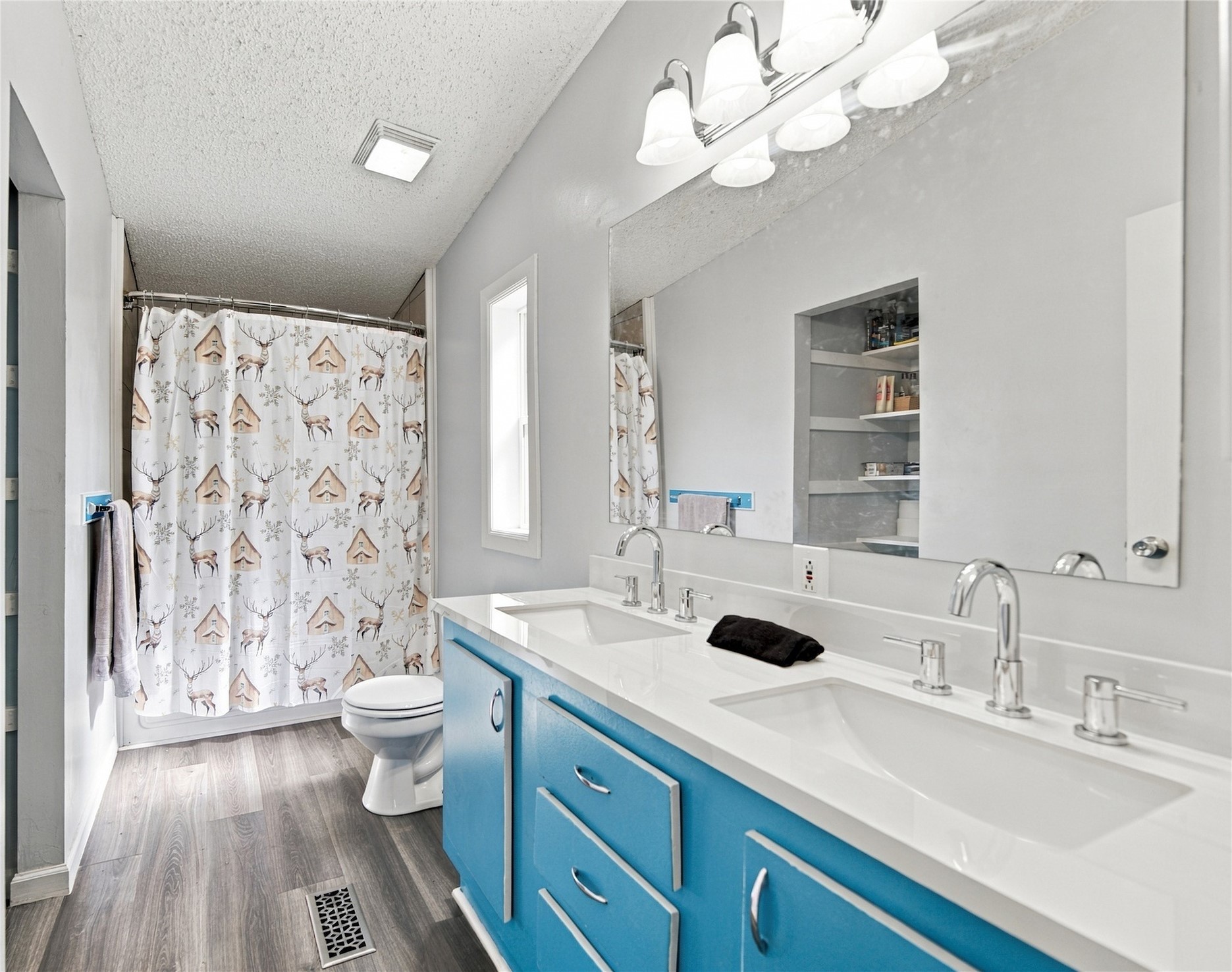 15 Sun Prairie Road Pryor, OK 74361 - Photo 15 of 34 Bathroom featuring a dual vanity with a white countertop and blue cabinetry, chrome fixtures, luxery vinyl flooring, and a storage closet