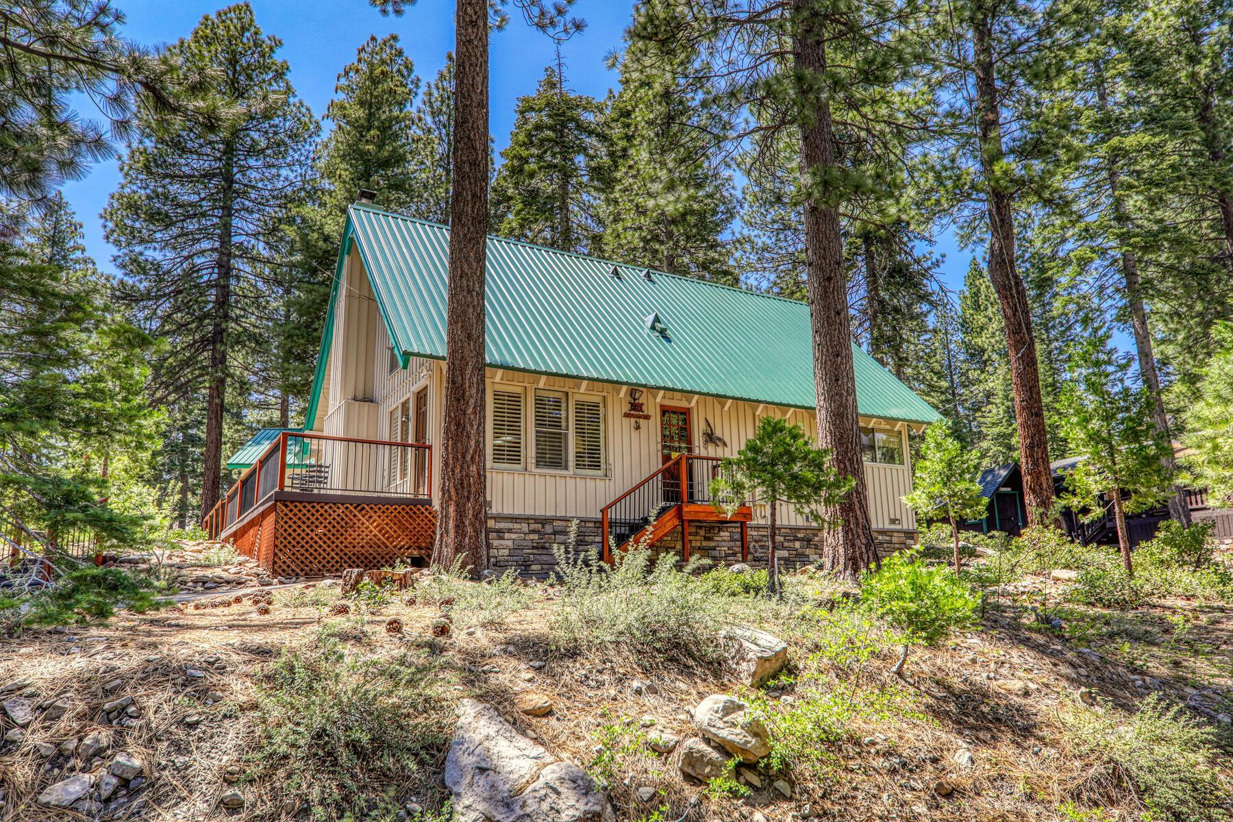 5775 Victoria Drive Carnelian Bay, CA 96140 - Photo 1 of 28 a view of a backyard with plants and a bench