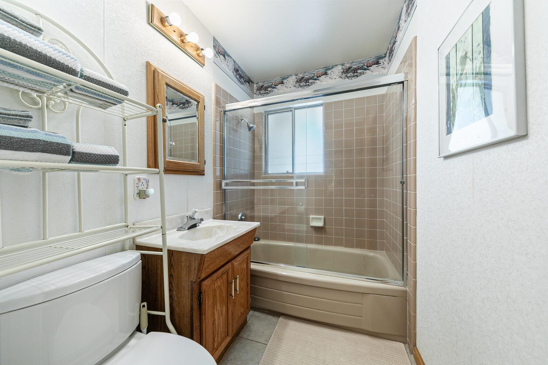 5775 Victoria Drive Carnelian Bay, CA 96140 - Photo 21 of 28 a bathroom with a sink toilet vanity and tub